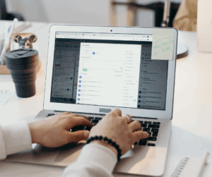 Person working on a laptop, creating or managing content, representing content marketing strategy and digital outreach.